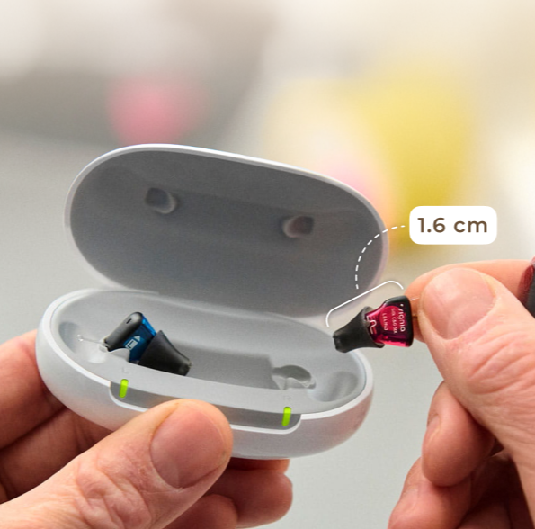 Silk Charge&Go 7IX hearing aids being placed into the portable charging case.