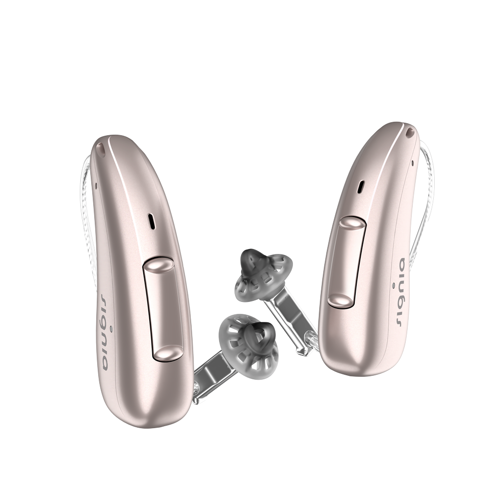 A pair of discreet Rose Gold Signia Charge and Go 3AX 7AX hearing aids profil
